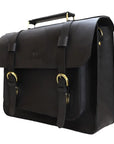 Black leather satchel bag with gold buckles on a white background