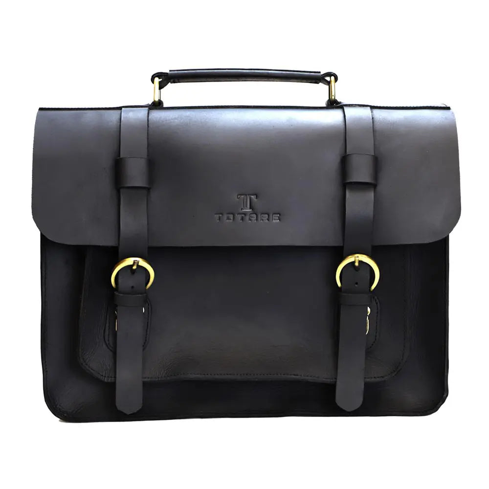 Black leather satchel bag with gold buckles on a white background