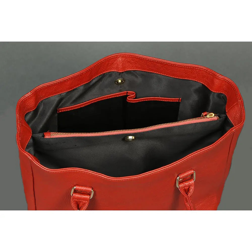 Red handbag with open top showing black interior on a gray background