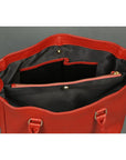 Red handbag with open top showing black interior on a gray background