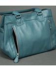Teal handbag on a gray background