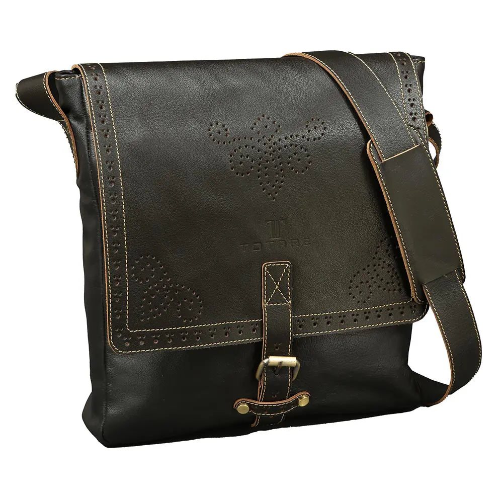 Black leather messenger bag with floral cut-out design on a white background