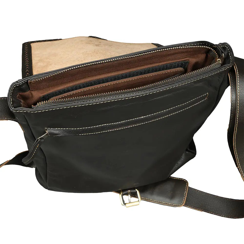 Black leather bag with a visible strap on a white background