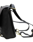 Black leather backpack with gold hardware on a white background