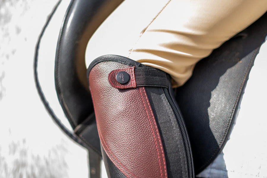 Close-up of a person wearing a protective arm guard on a vehicle's steering wheel.