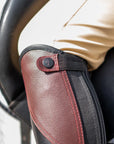 Close-up of a person wearing a protective arm guard on a vehicle's steering wheel.