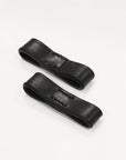 Two black leather straps on a white background