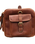 Brown leather bag with a buckle on a white background