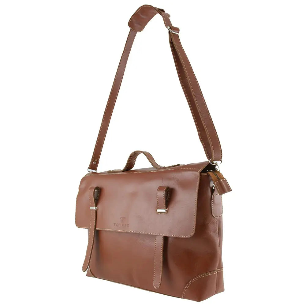 Brown leather bag with a strap on a white background