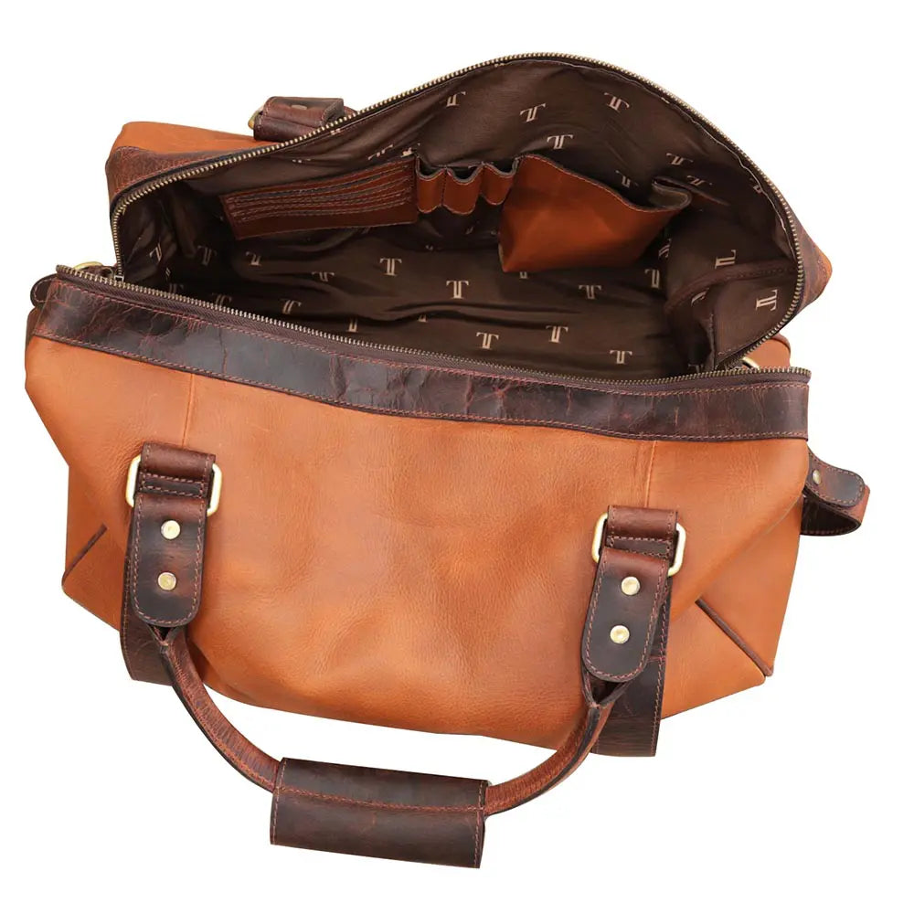 Brown leather bag with gold hardware on a white background