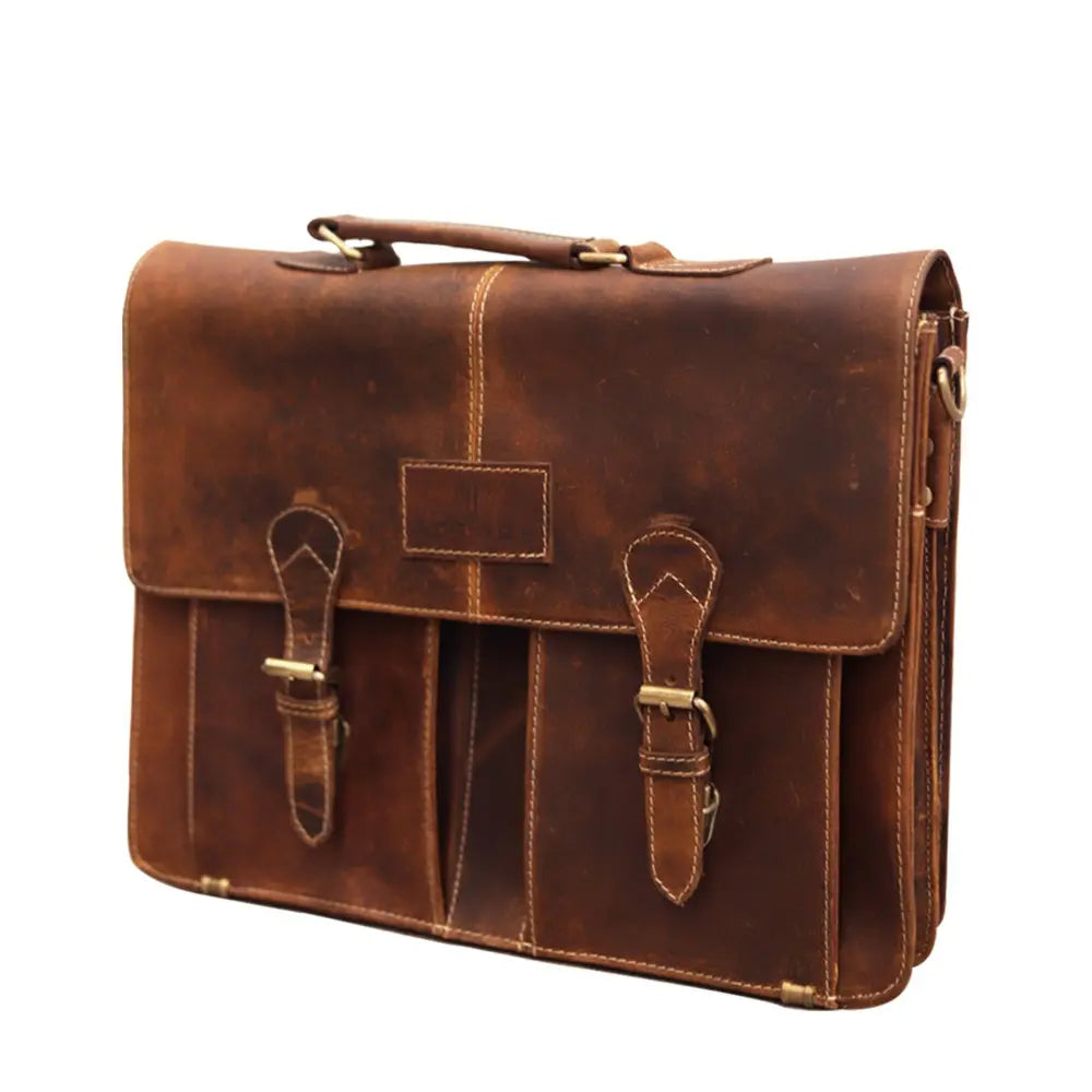 Brown leather satchel bag with gold buckles on a white background