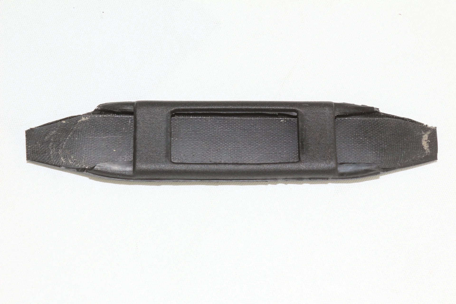 Black plastic component on a white background